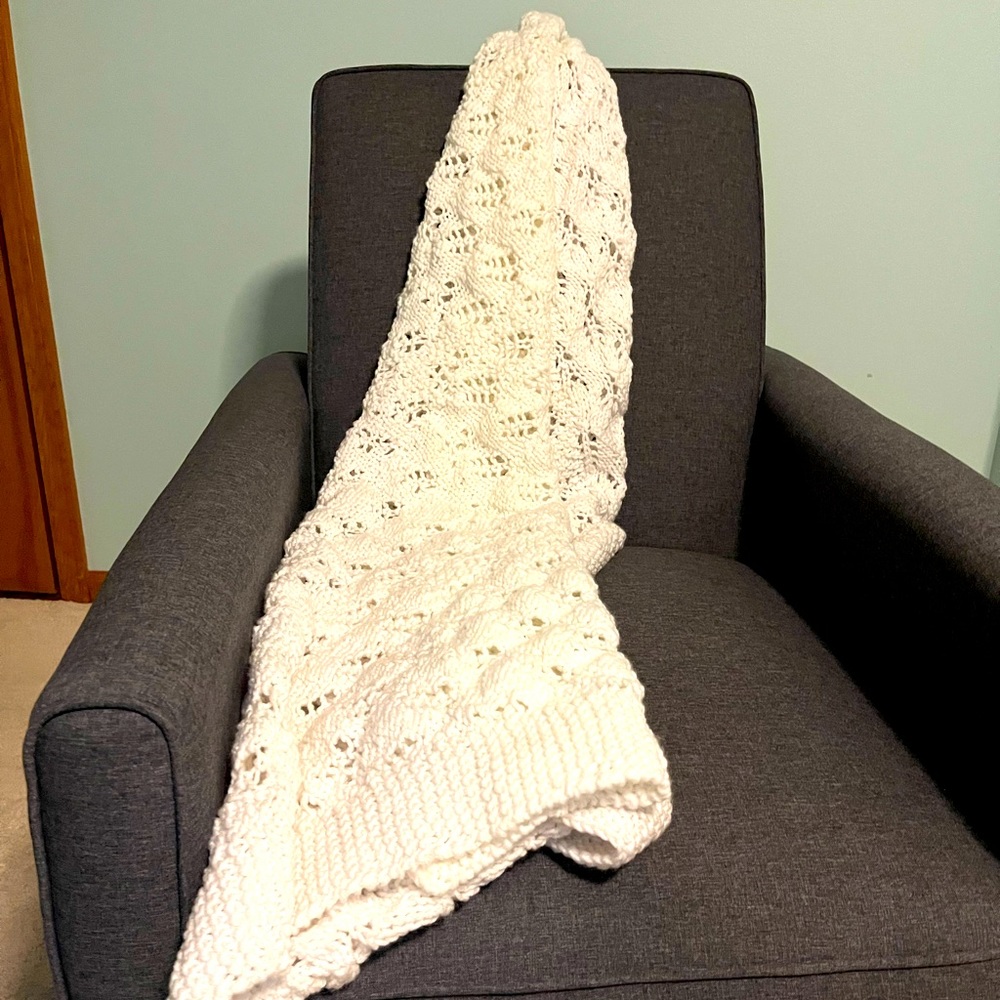 Hand crafted afghan in white. 36” x 54” great neutral can be used in any room.